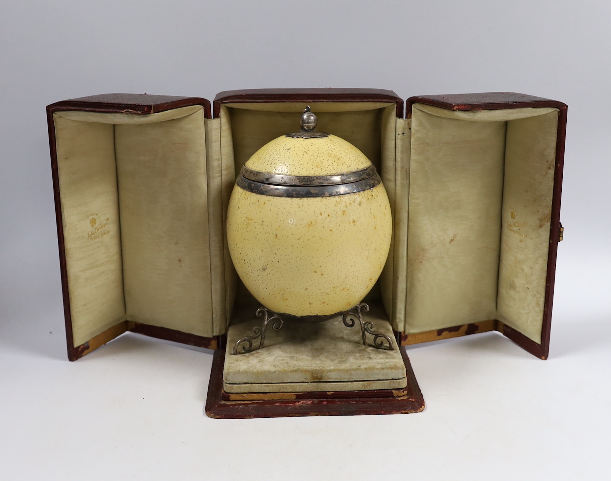 A cased Edwardian silver mounted ostrich egg, with silver mounted cover, Samuel Jacob, London, 1907, housed in a leather and watered silk case, 18.6cm.